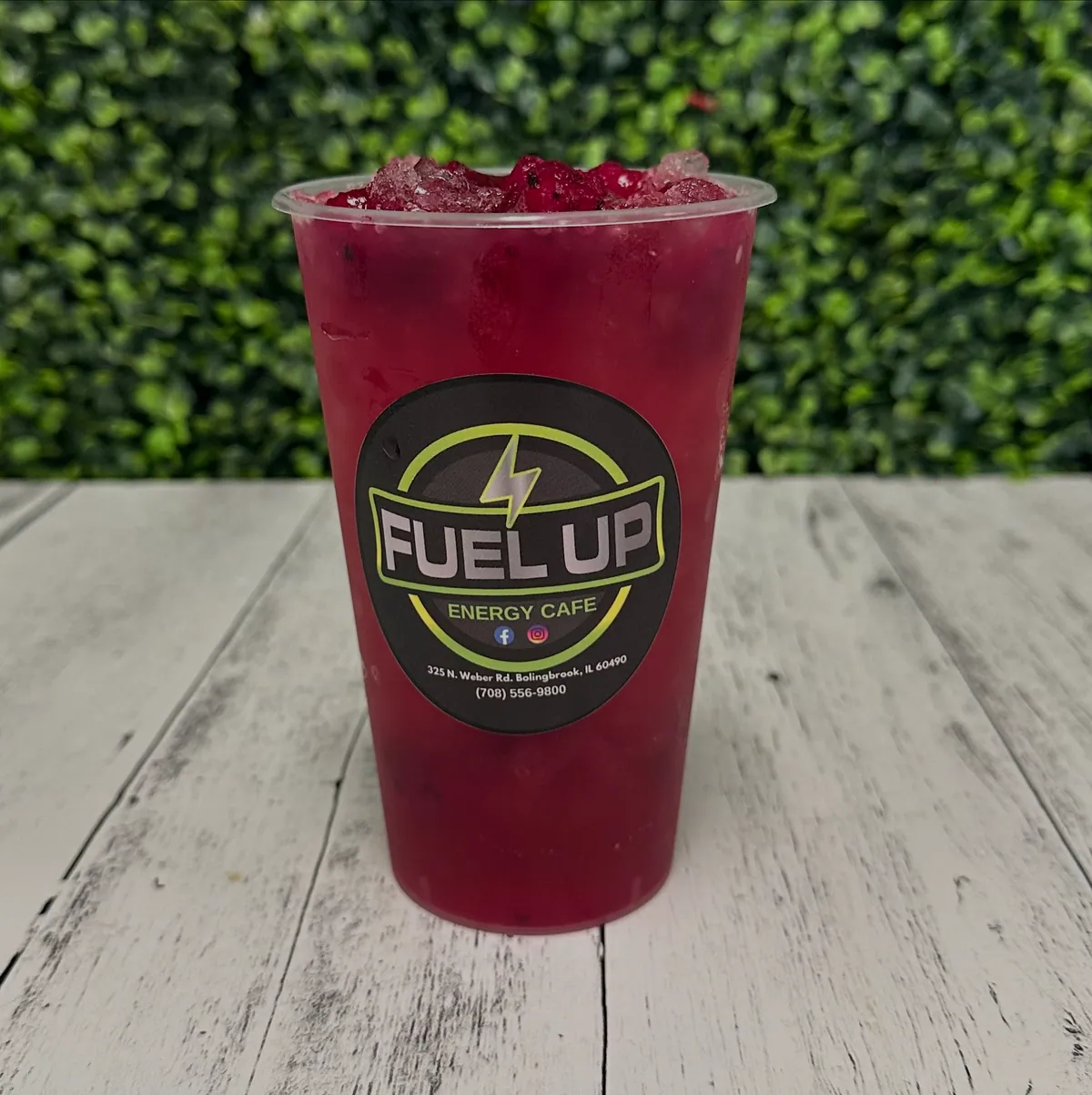 A deep berry-red Fuel Up refresher on whitewashed wood