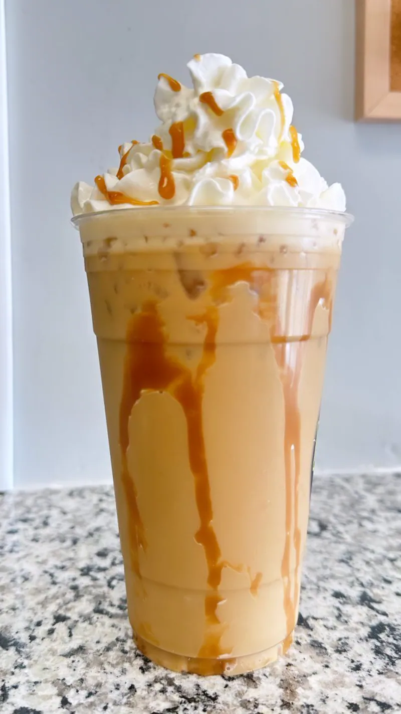 Iced protein coffee with whipped topping and caramel drizzle