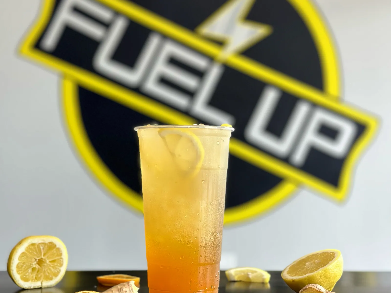 A citrus wellness refresher with lemon and ginger in front of the Fuel Up logo